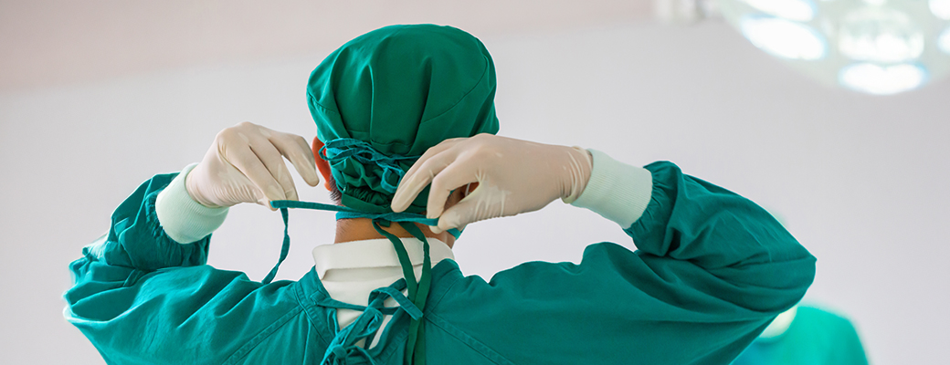 Behind view of a hearing care professional preparing for surgery